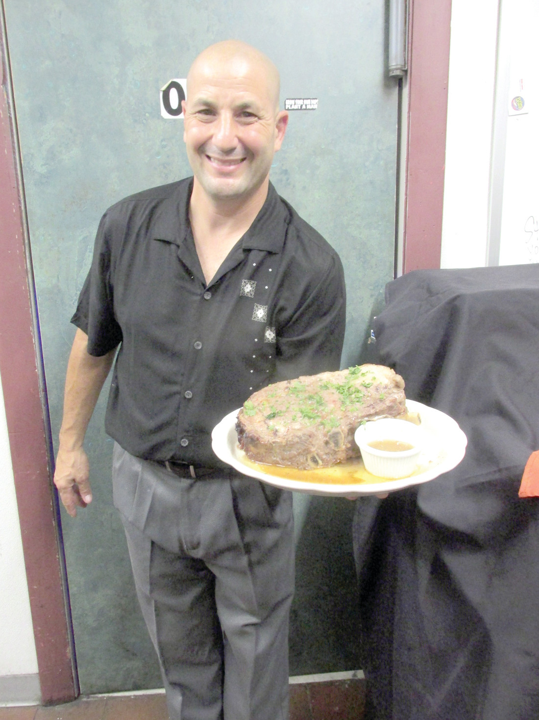 COLASSAL CUT: David Lombardo, owner of The Ave Restaurant Bar & Grill in Johnston, shows off the32-ounc cut of prime rib some people enjoyed during last Friday night’s Grand Opening.
